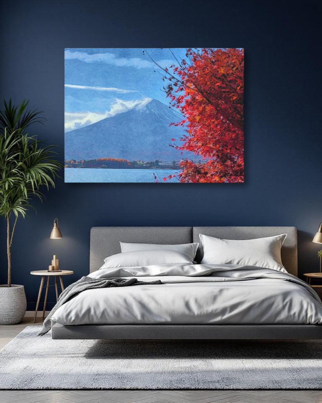 A large archival canvas print of the Mount Fuji autumn watercolor study hanging in a modern bedroom with dark blue walls and a gray upholstered bed.
