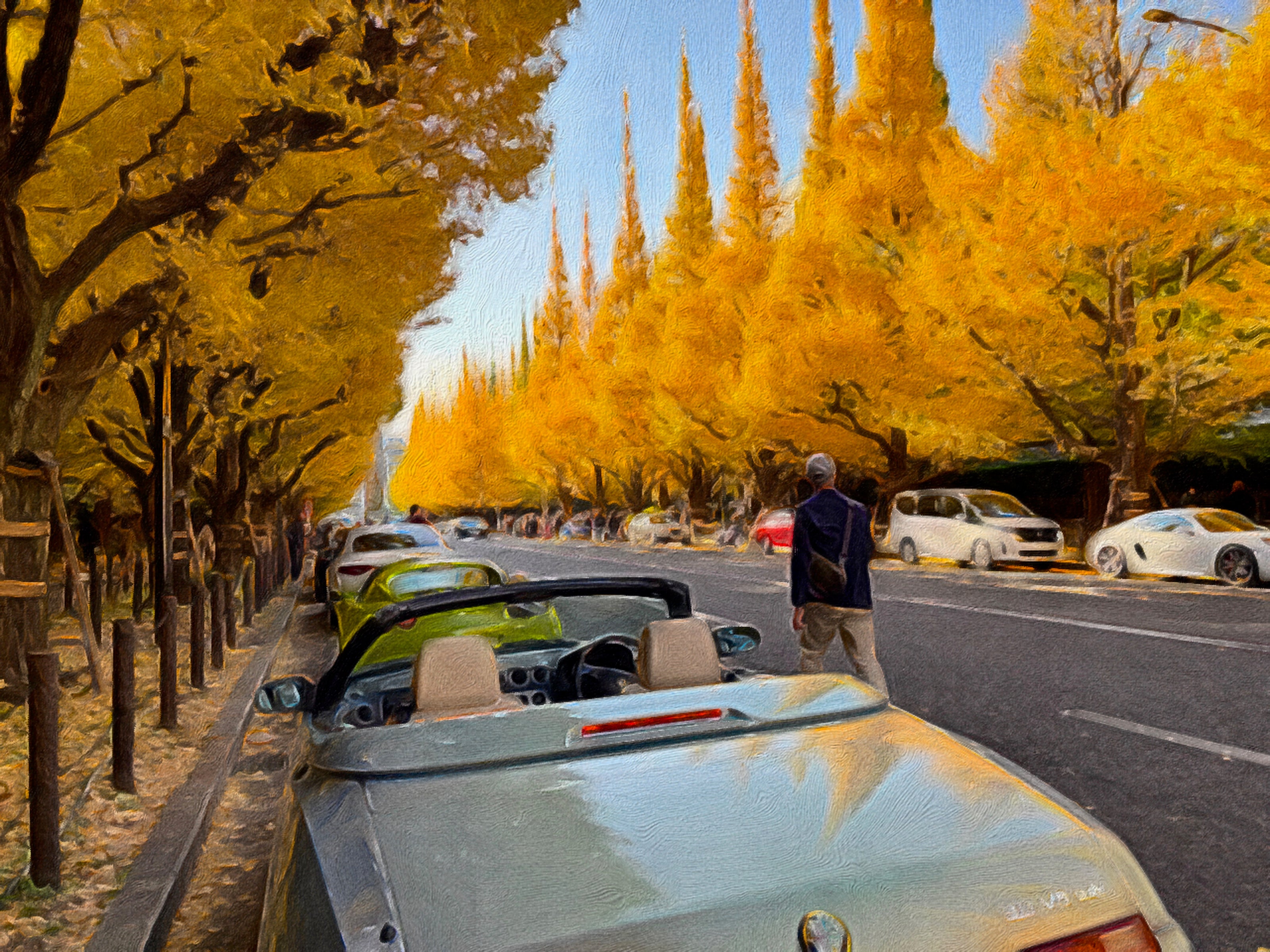 After Image: View from behind a silver Alfa Romeo Spider convertible parked along a Tokyo street lined with towering, vibrant yellow ginkgo trees under a clear blue sky during autumn.